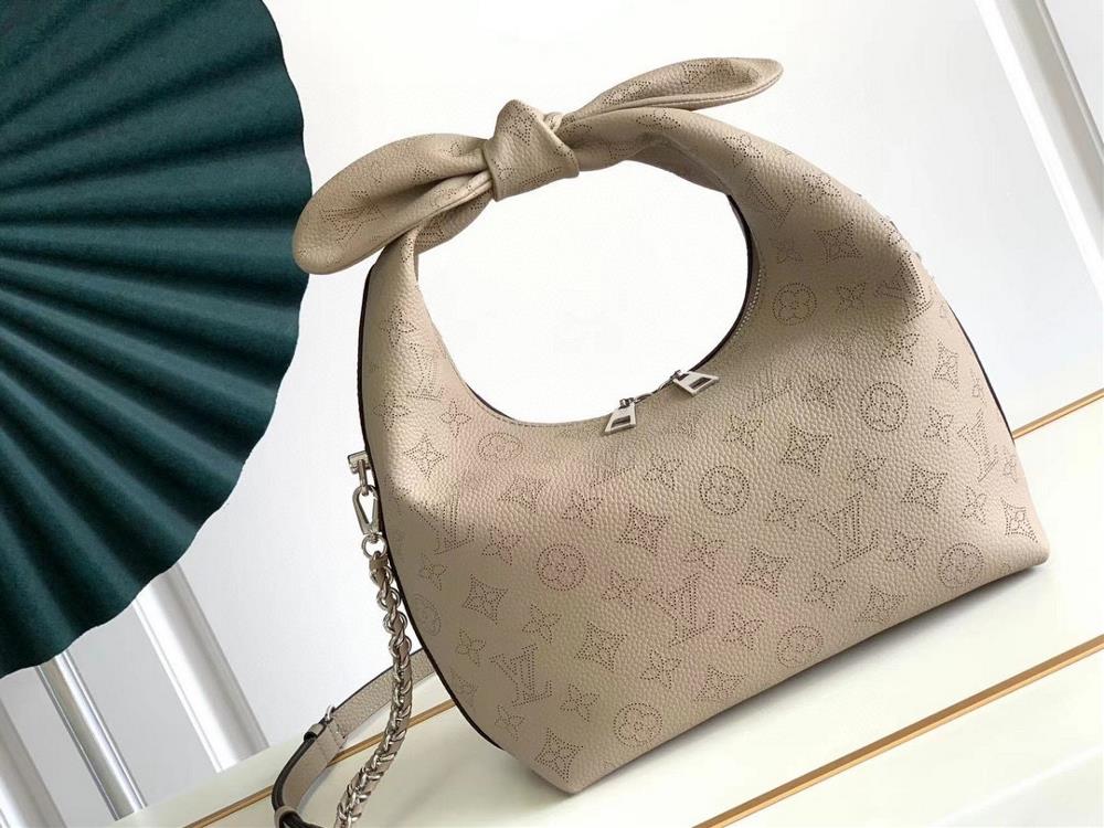 The M20700 M20703 Why Knot small handbag is made of iconic Monogram perforated cowhide leather combined with a knot shaped handle revealing a gentle