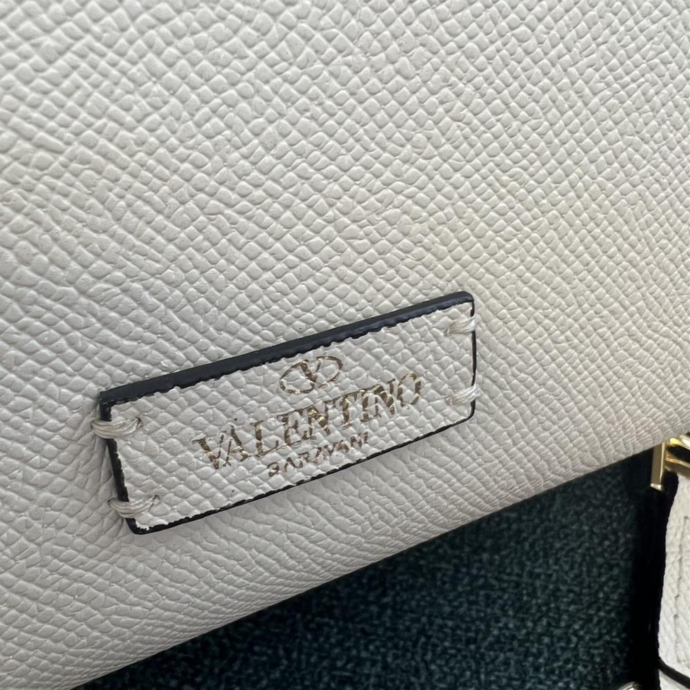 Owning a Valentino Bag GARAVANI VSLING adorned with Swarovski Crystals is not just abou