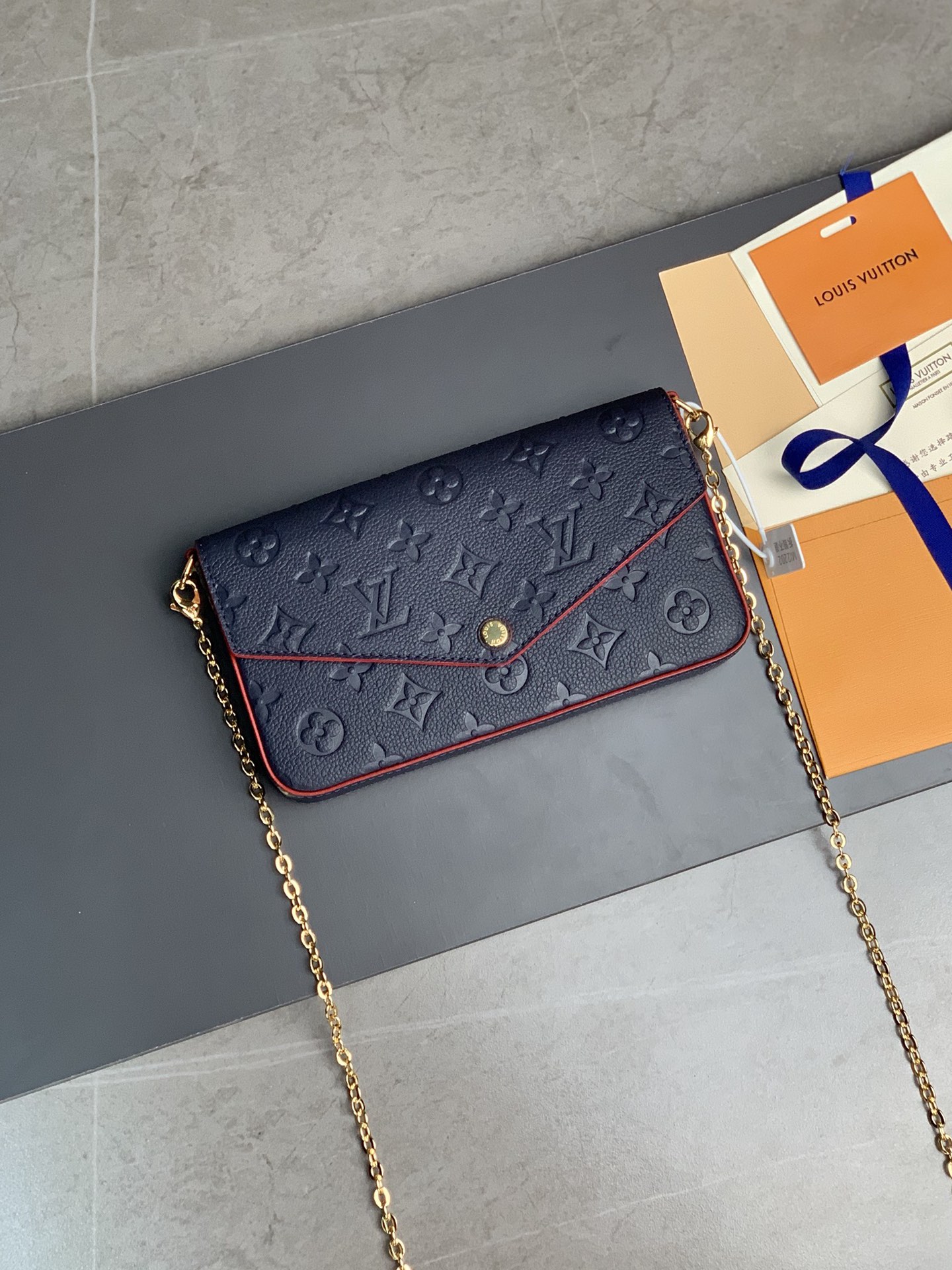 M64064 navy blue The Pochette F  licie Chain Bag is made of Monogram Imprente cowhide fabric and fea