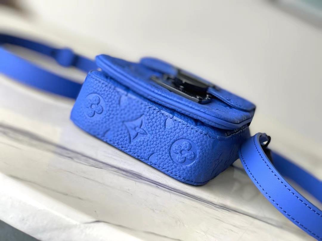 The M82568 blue SLock Vertical mini handbag features an iconic SLock buckle inspired by G