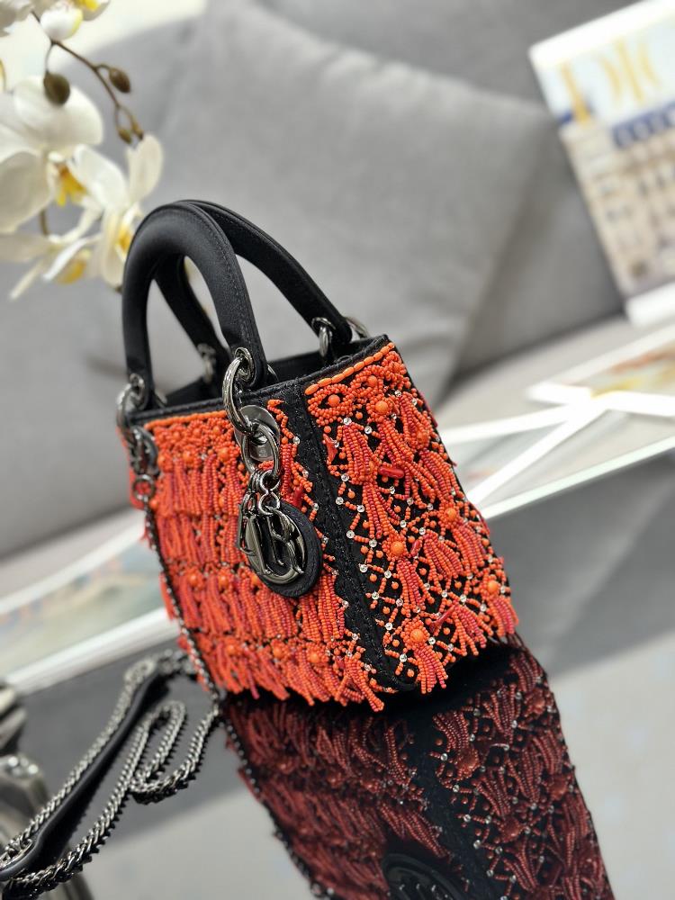 The choice of coral red beads for this edition of the Lady Dior bag is a stroke of genius