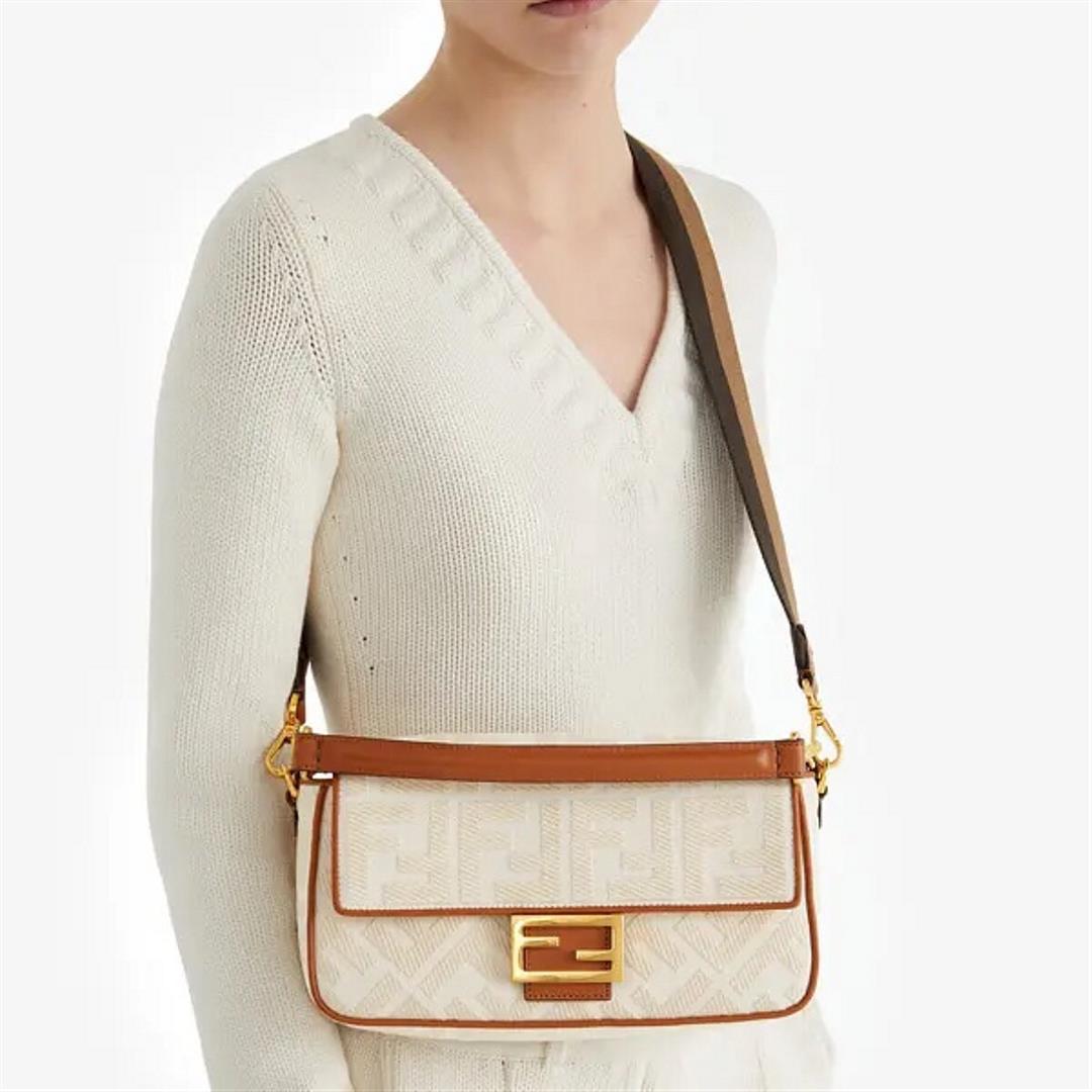 The FEND1 iconic Baguette handbag is made of white canvas material adorned with FF pattern emb