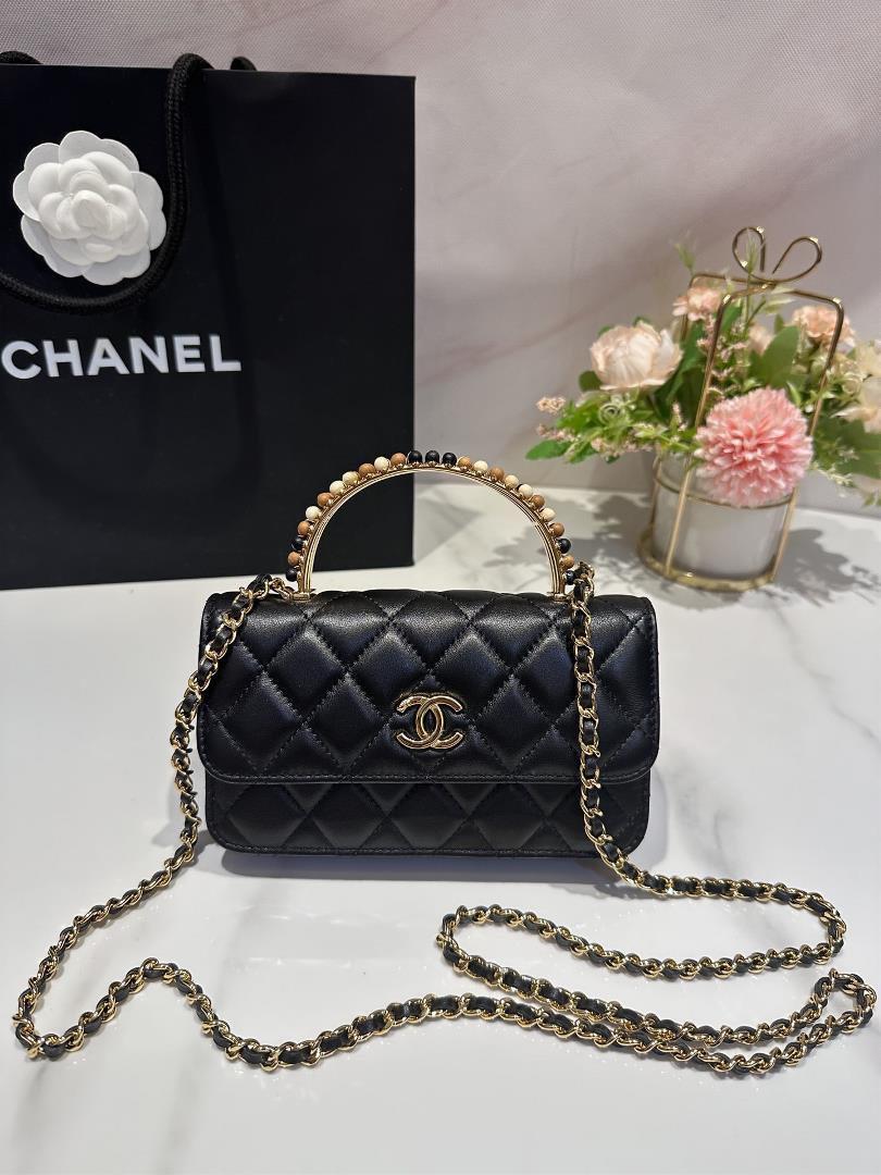 The Chanel 23A Wooden Bead Handle Mobile Phone Bag Handicraft Workshop series features exquisite cho