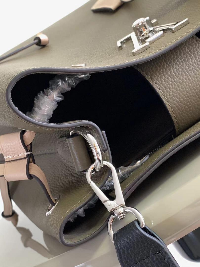 M54677s latest water bucket bag features imported soft calf leather with a shiny twist lo