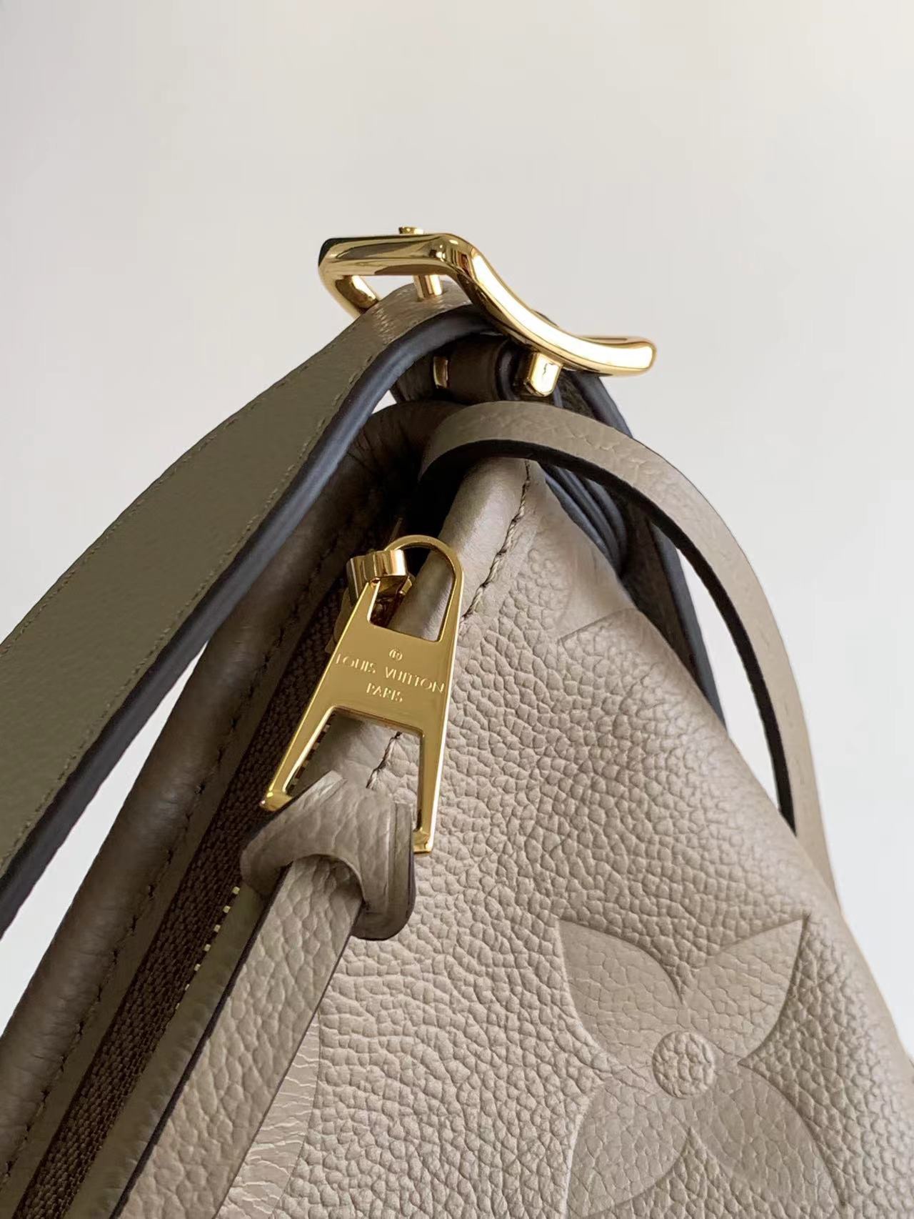 M46289 matching details CarryAll medium size handbag is made of Monogram Imprente embossed lea