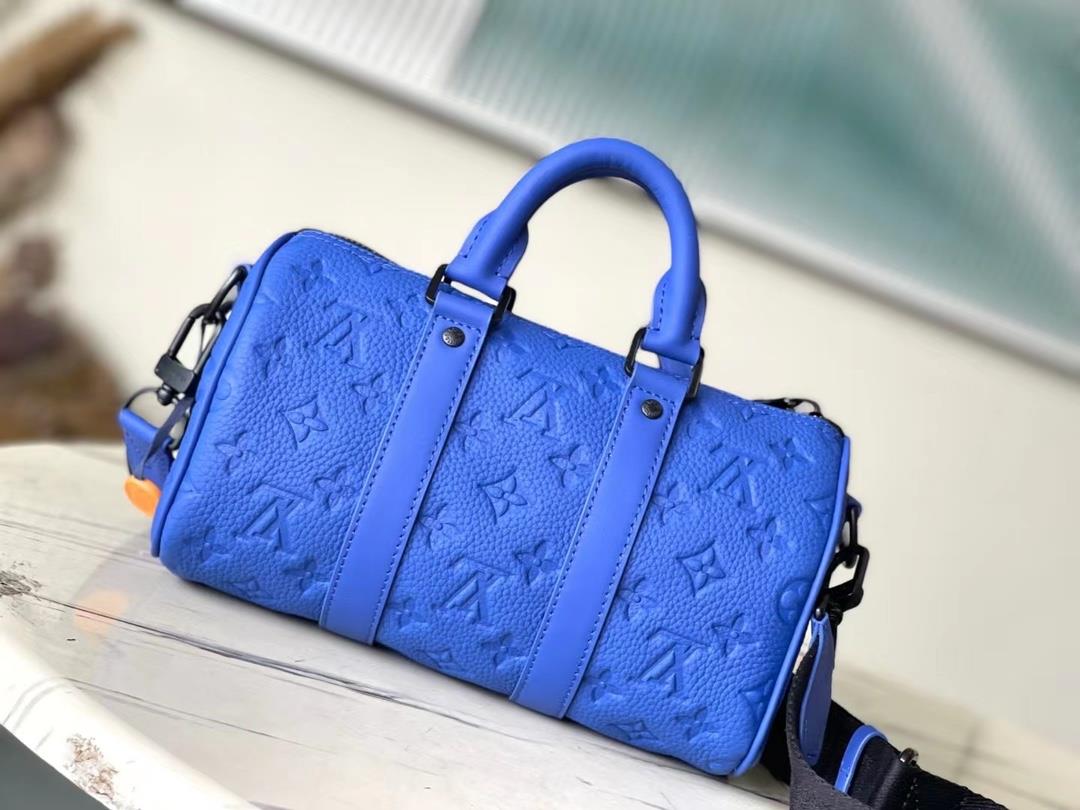 The toplevel original M23129 blue Keepall Bandoulire 25 handbag features Monogram embosse