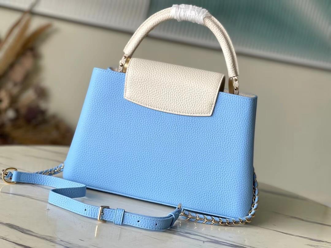 M21887 blue medium size Taurilon leather version of the Capuchines handbag presents a soft