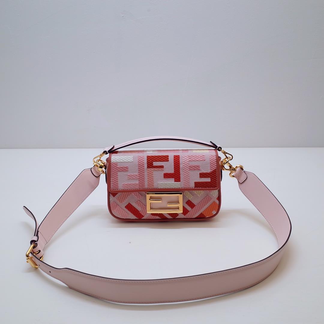 The FEND1 iconic Baguette handbag is made of canvas material and is adorned with red and pink FF emb