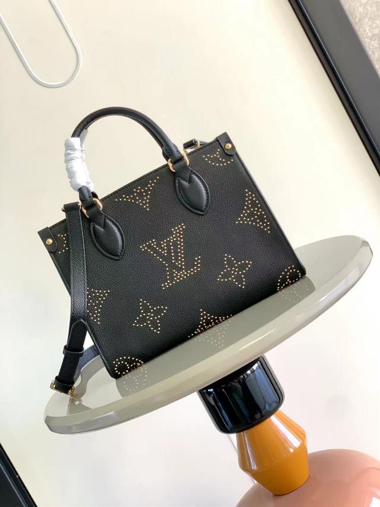 M46733 black with nails 45653 This On TheGo small tote bag features a Giant Monogram pattern made of grain leather accents and studs complementing th