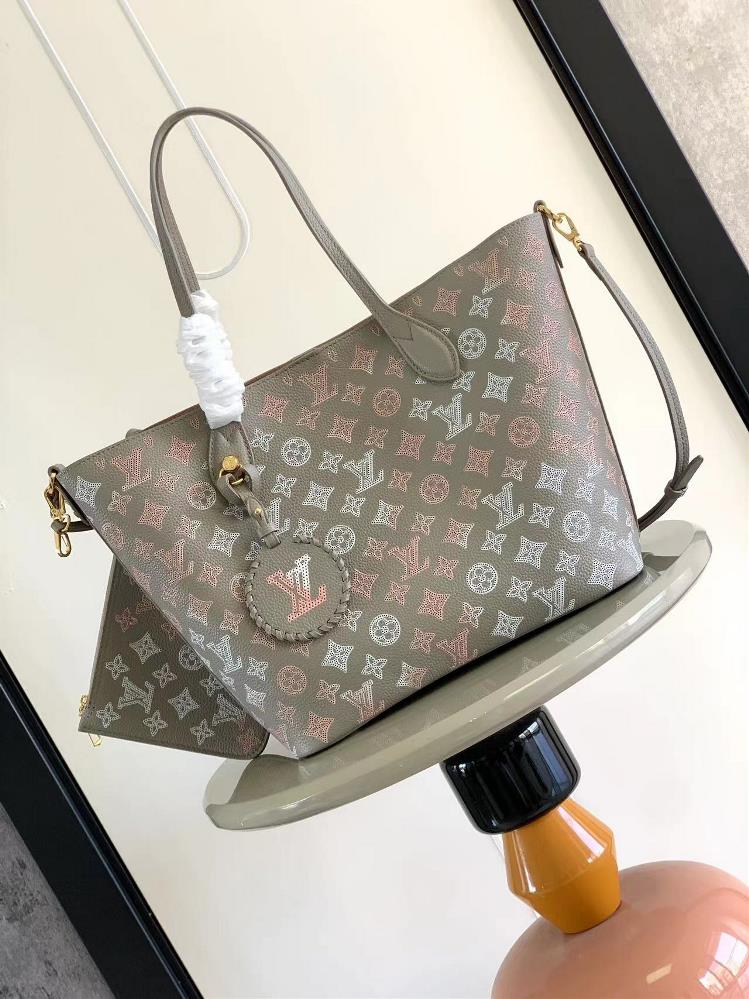 M23387 gray screen printed Blossom Medium Tote bag is made of lightweight engraved cow leather and features a perforated Monogram pattern on top of el