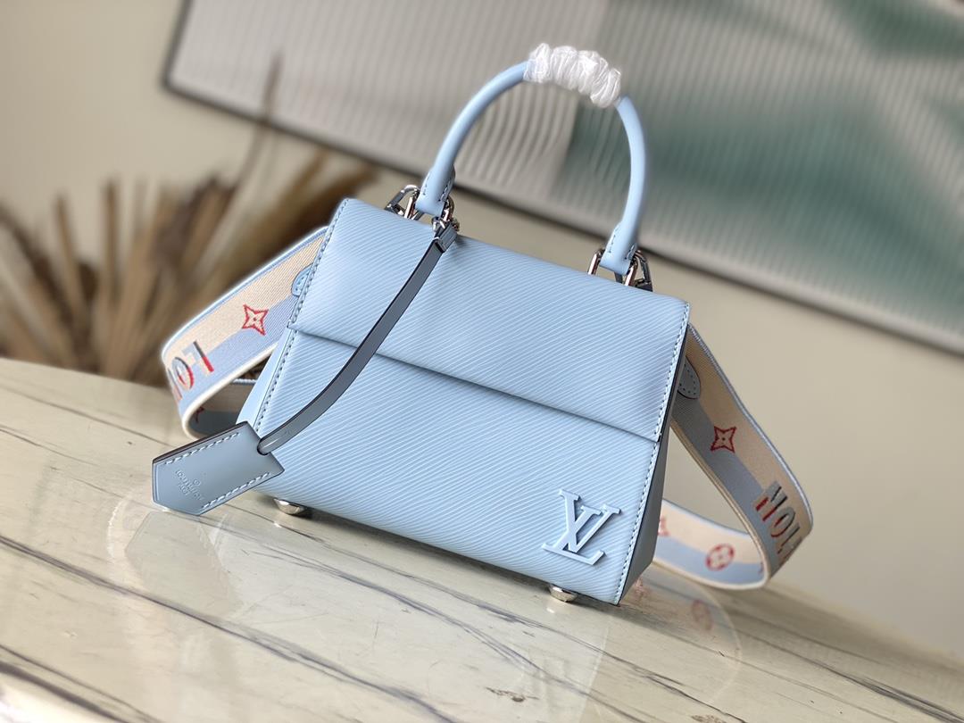 M22617 58931 Sky Blue This Cluny mini handbag conveys a fresh summer style with the unique texture o