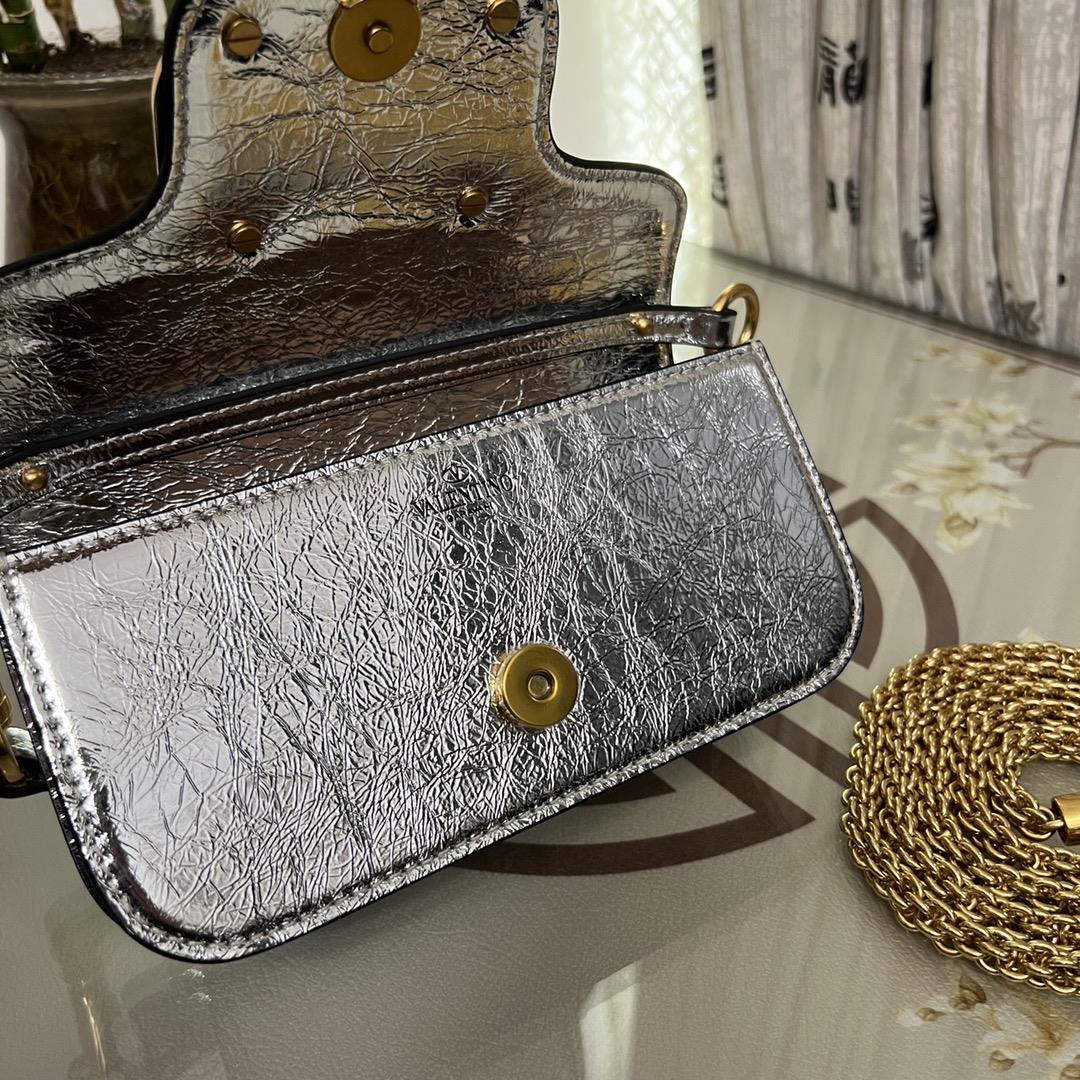 Small Garavani MINI LOC calfskin handbag with metal VLogo Signature detailsEquipped with detac