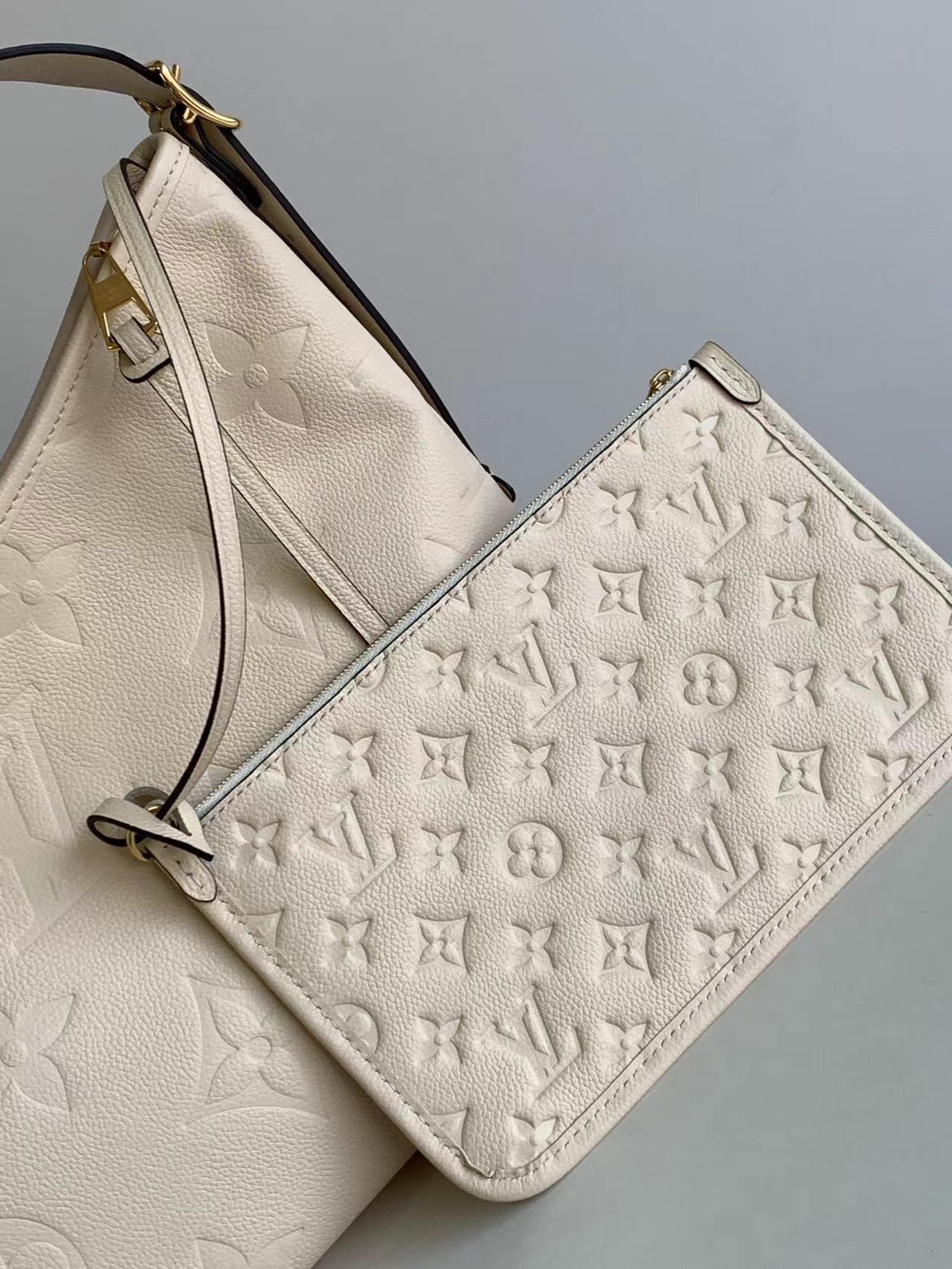 M46289 matching details CarryAll medium size handbag is made of Monogram Imprente embossed lea