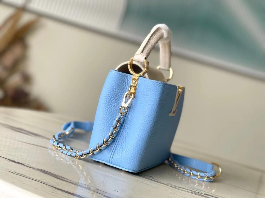 M21887 blue mini Taurilon leather version of the Capuchines mini handbag presents a soft a