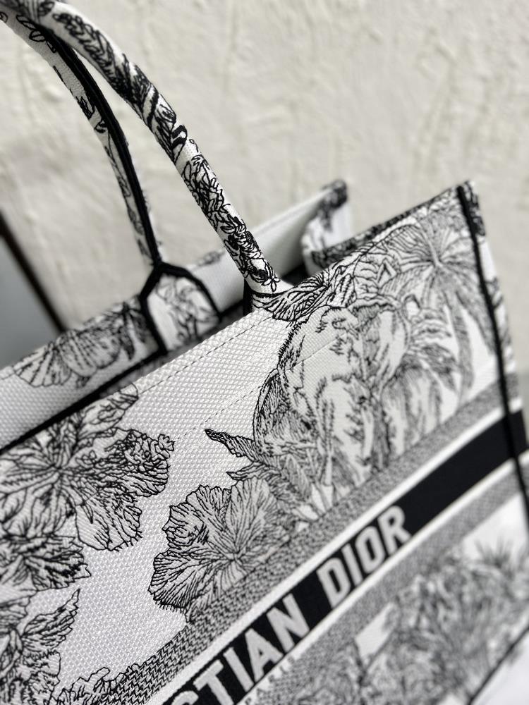 What sets the Dior Bag Tote Book Tote handbag apart from other designer bags is its non