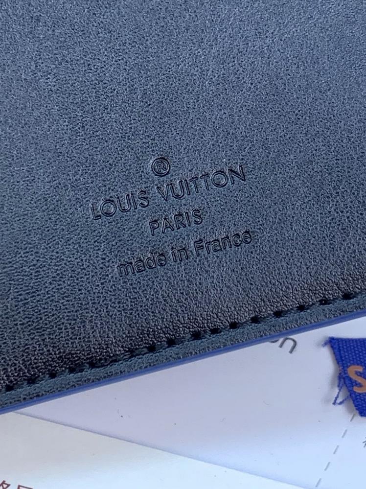 The M61697 Deep Blue Brazza wallet features a soft Taurillon leather embossed Monogram pat