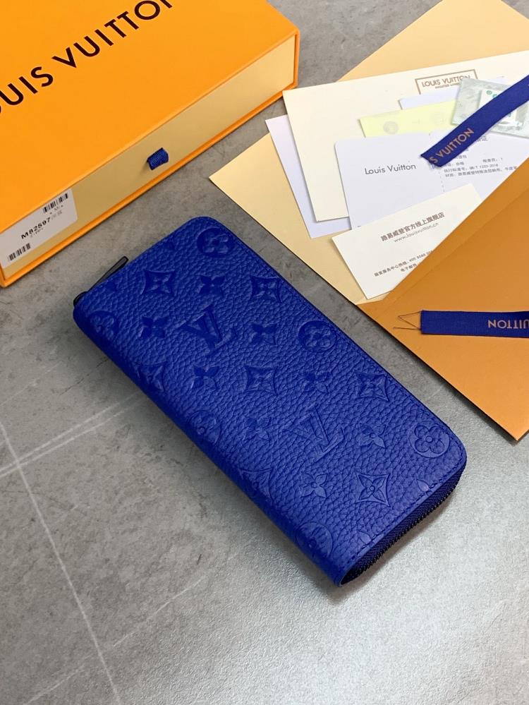 The M82597 Deep Blue Zippy Vertical wallet features a soft Taurillon leather embossed Monogram pattern and a sleek full zipper structure with a card s