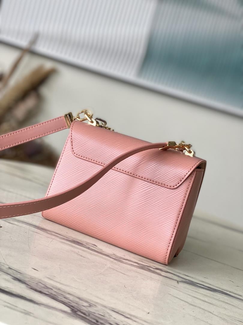 M23074 Peach PowderThis Twist small handbag incorporates the brands iconic Monogram flowe