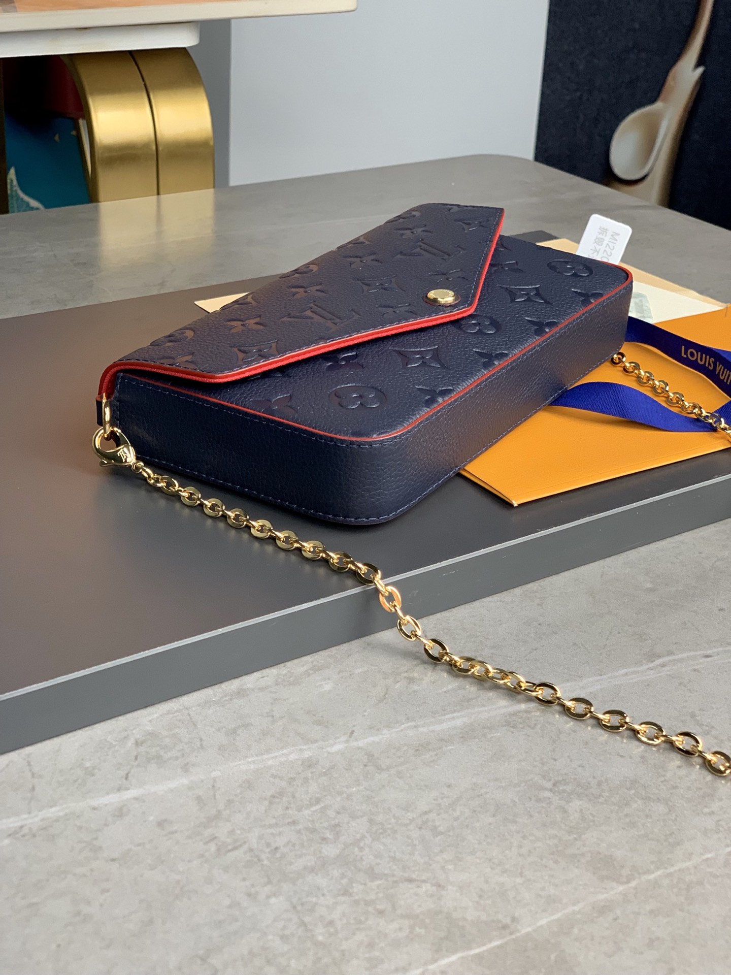 M64064 navy blue The Pochette F  licie Chain Bag is made of Monogram Imprente cowhide fabric a