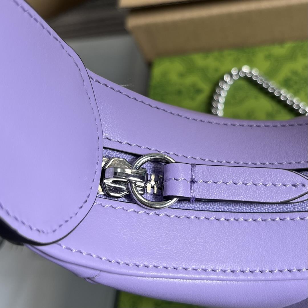 Equipped with a full set of packaging this mini handbag features a crescent shaped silhouette 