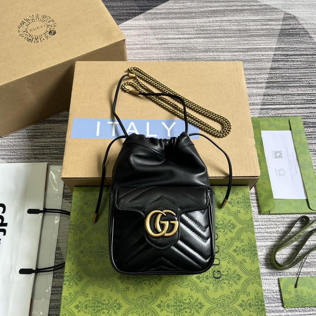 this mini bucket bag is crafted with black quilted Vshaped leather As a iconic element of the GG M