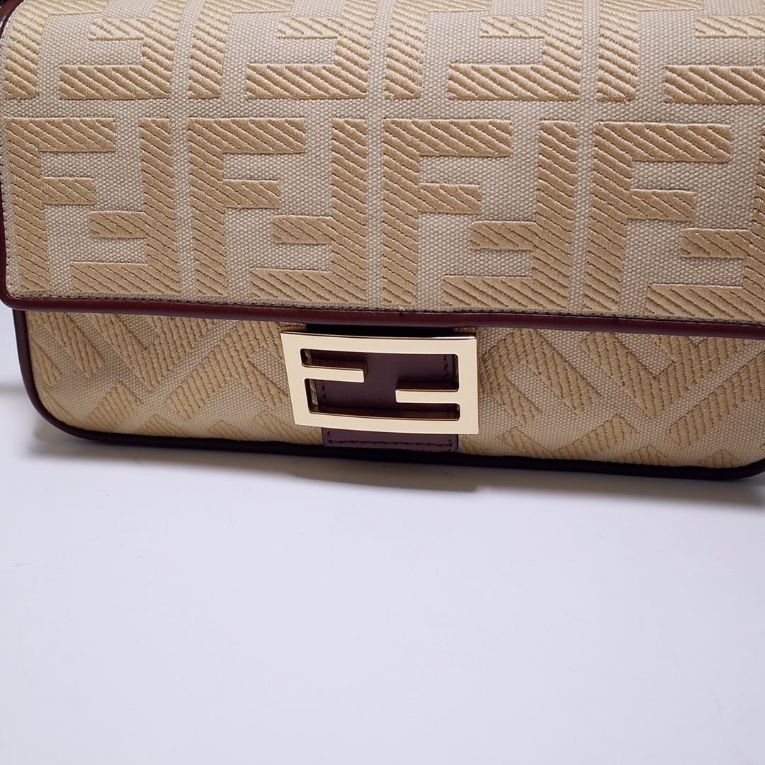 The FEND1 iconic Baguette handbag is made of beige canvas material adorned with FF pattern emb