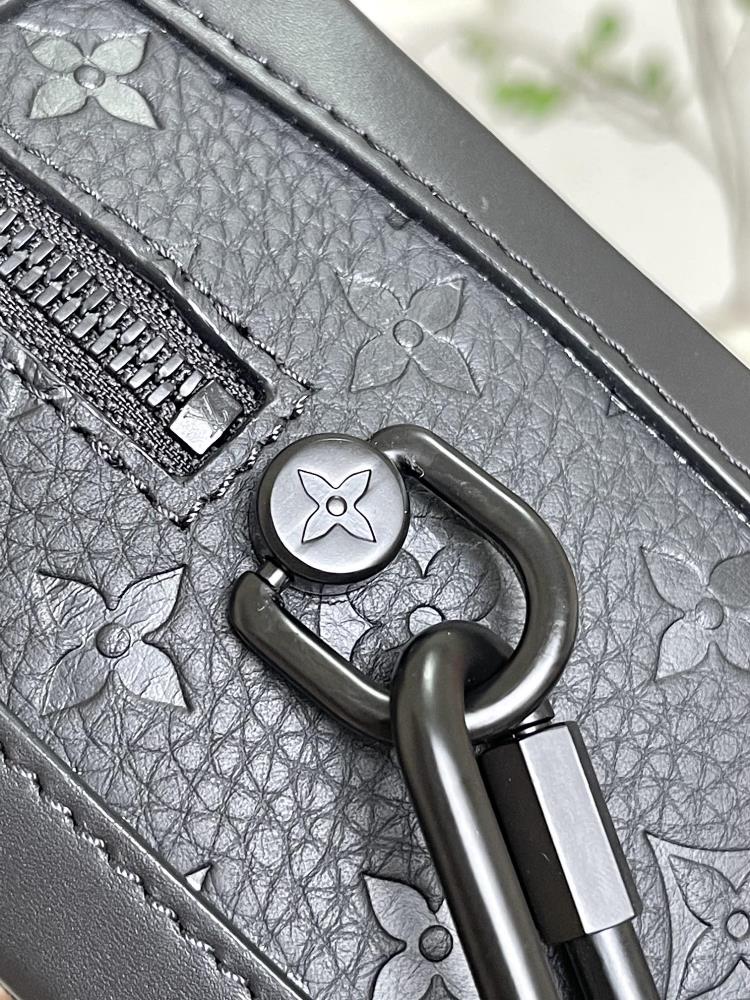 The M55700 Soft Trunk handbag combines Monogram embossed Taurillon leather matte zippers