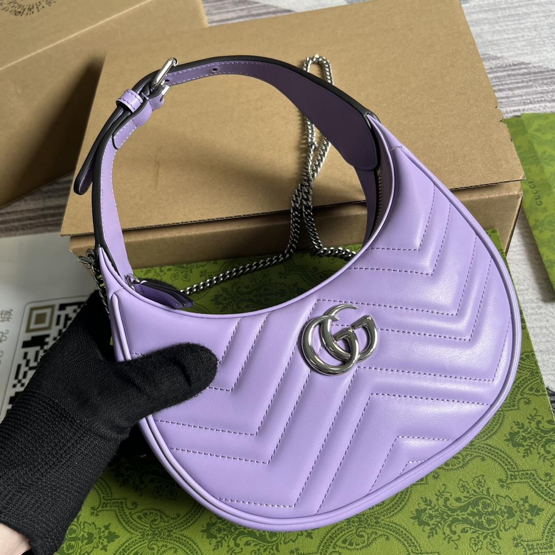 Equipped with a full set of packaging this mini handbag features a crescent shaped silhouette 